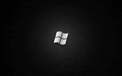 A metallic window mark sits at the centre of a fine honeycomb mesh, catching light along its top edge.