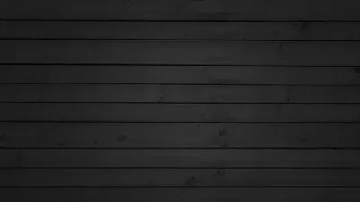Horizontal charcoal planks run the width of the frame, grain and nail marks showing where the light grazes across the middle boards.