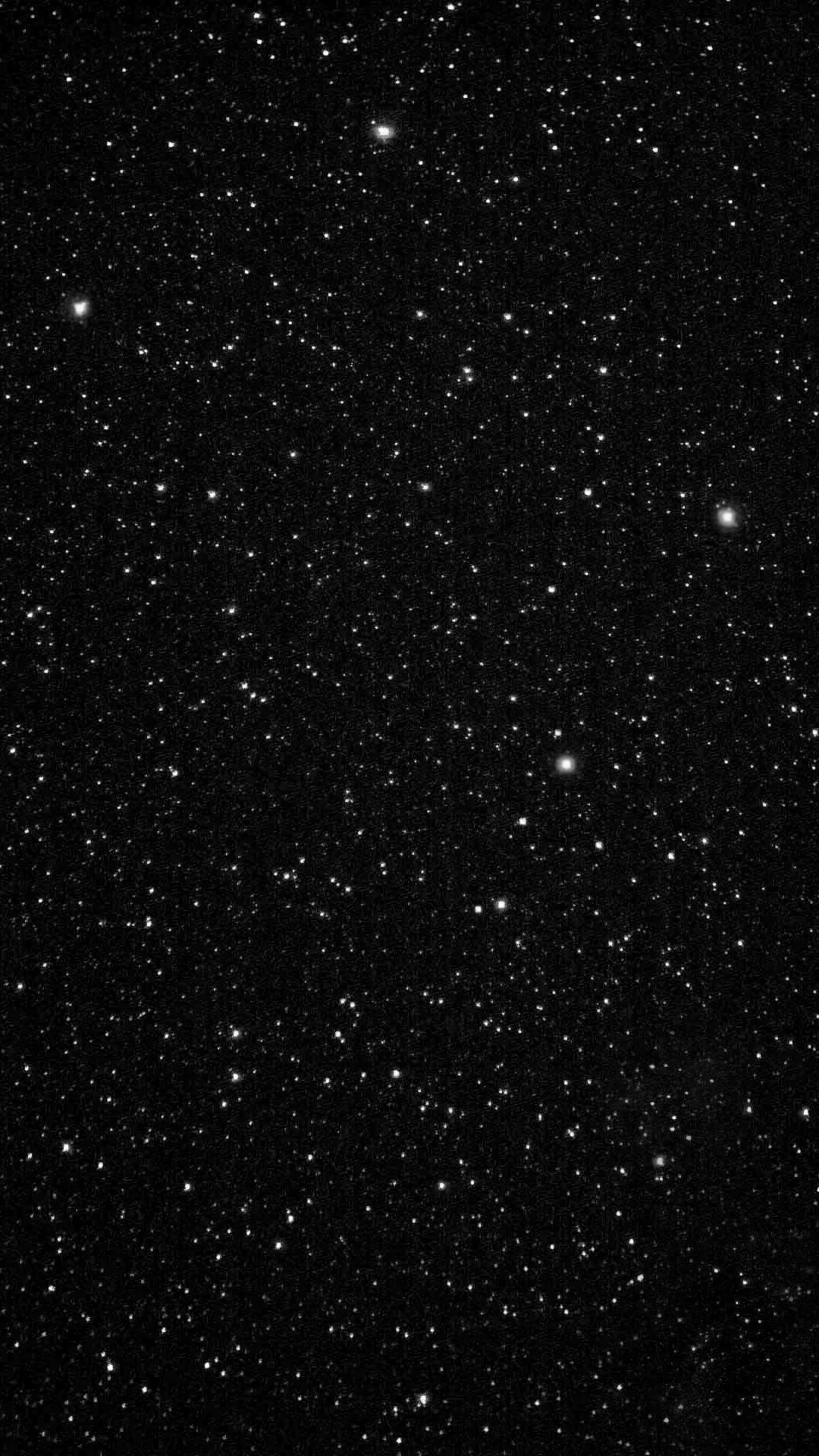 Thousands of small white stars packed evenly across deep black, thinning slightly toward the top so clock and icons stay readable.