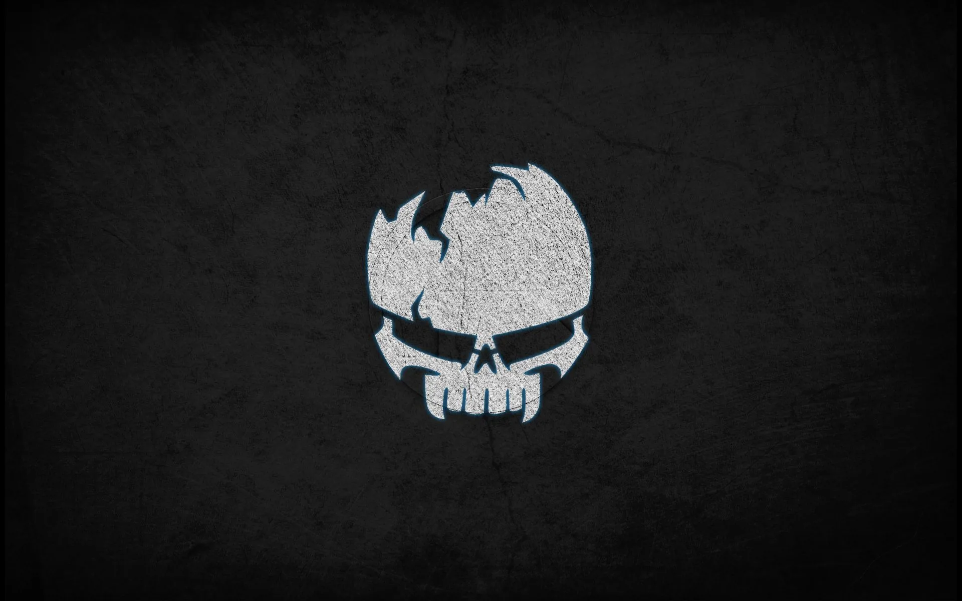 A broken skull mark sits high in the frame, drawn in speckled white grain over a rough charcoal wall with a soft vignette.