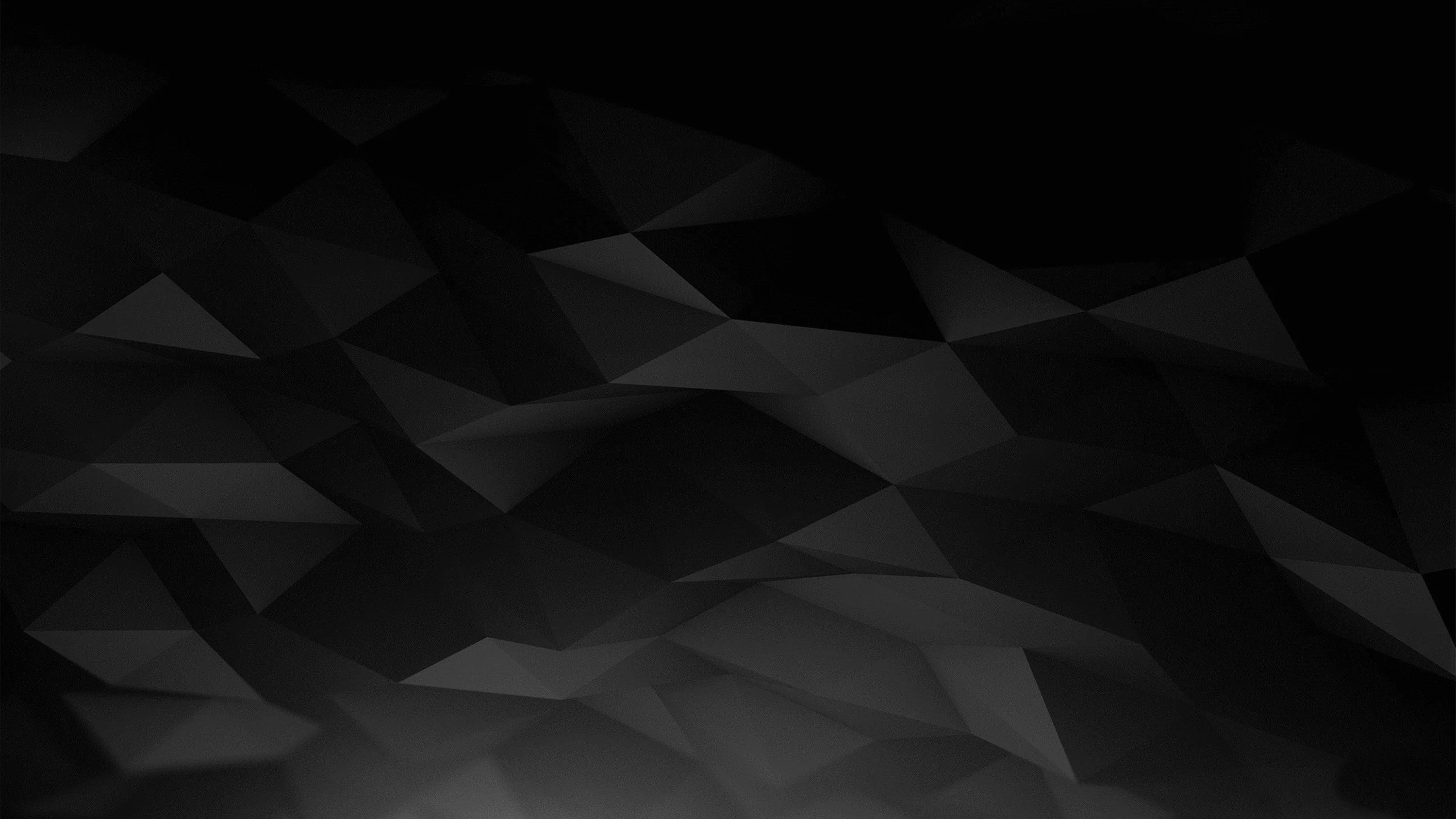 Faint triangular facets tile a near-black field, lightest along the lower left and dropping away to the corners.