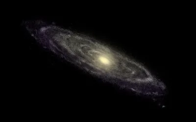 The spiral of Andromeda sits small and off-centre with a yellow core, the rest of the frame left as flat black for OLED screens.