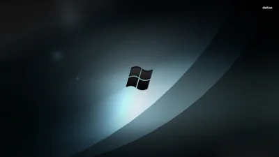 The classic four-flag Windows logo floats at centre on a deep blue-black gradient, a wide soft beam of light crossing behind it.