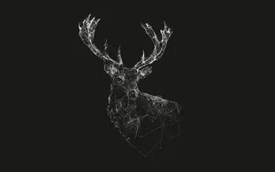 A stag turns its antlers into the light, its whole form built from scattered white fragments dissolving into the dark at the shoulders.