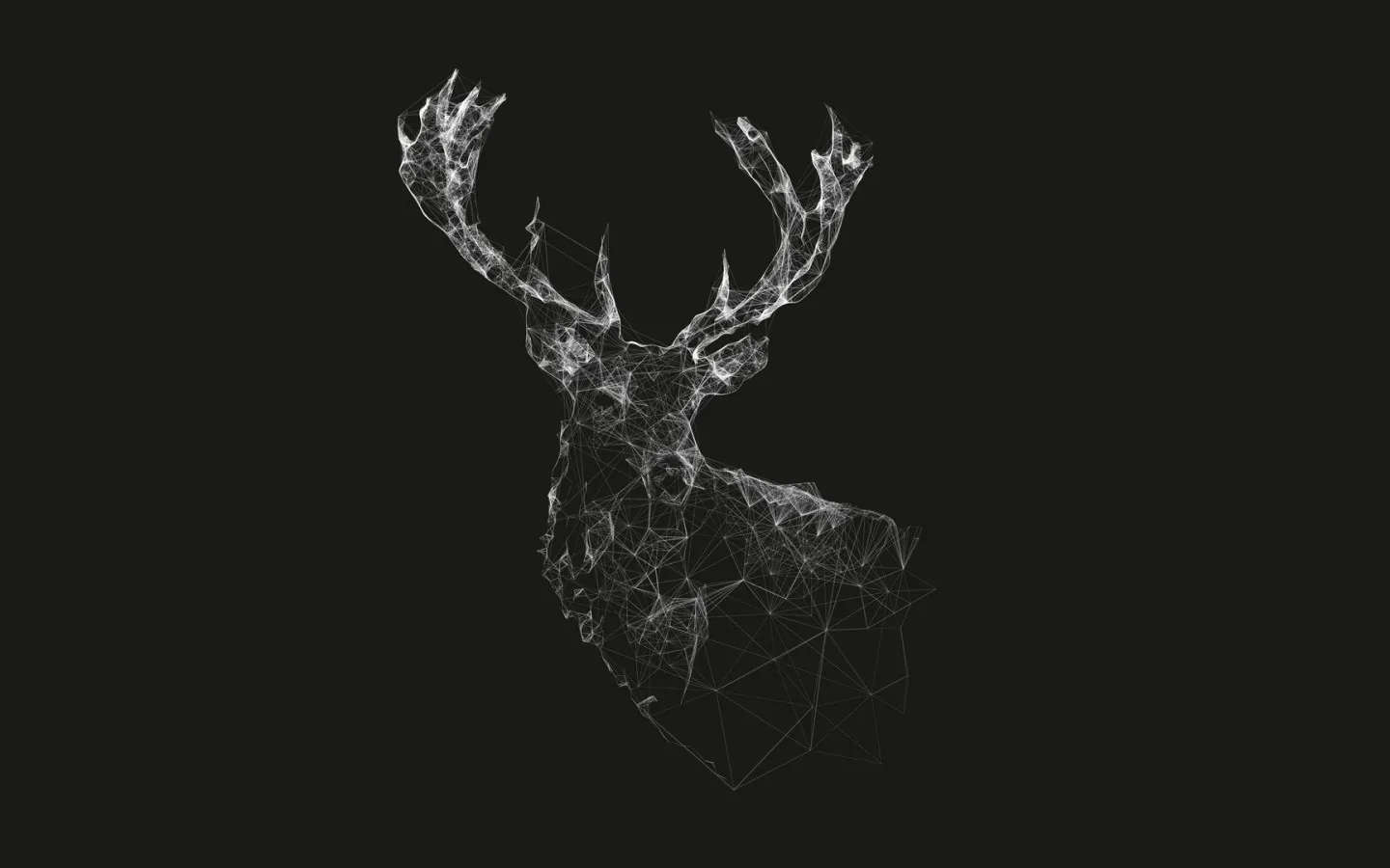 A stag turns its antlers into the light, its whole form built from scattered white fragments dissolving into the dark at the shoulders.