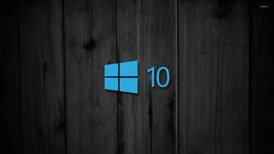 The blue logo and the number 10 sit on vertical grey-black boards, the grain and plank seams still readable behind them.