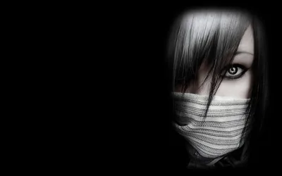 A face emerges from the left with a wrap over the mouth and hair falling across one eye, the rest of the frame black.