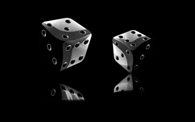 A pair of glossy black dice with white pips sit on a mirrored surface against pure black, their reflections stretching down into the lower half.