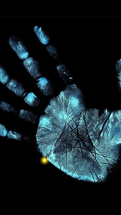 An open palm lit from within like an x-ray, the skin cracked with blue veins and a single small yellow spark near the wrist.