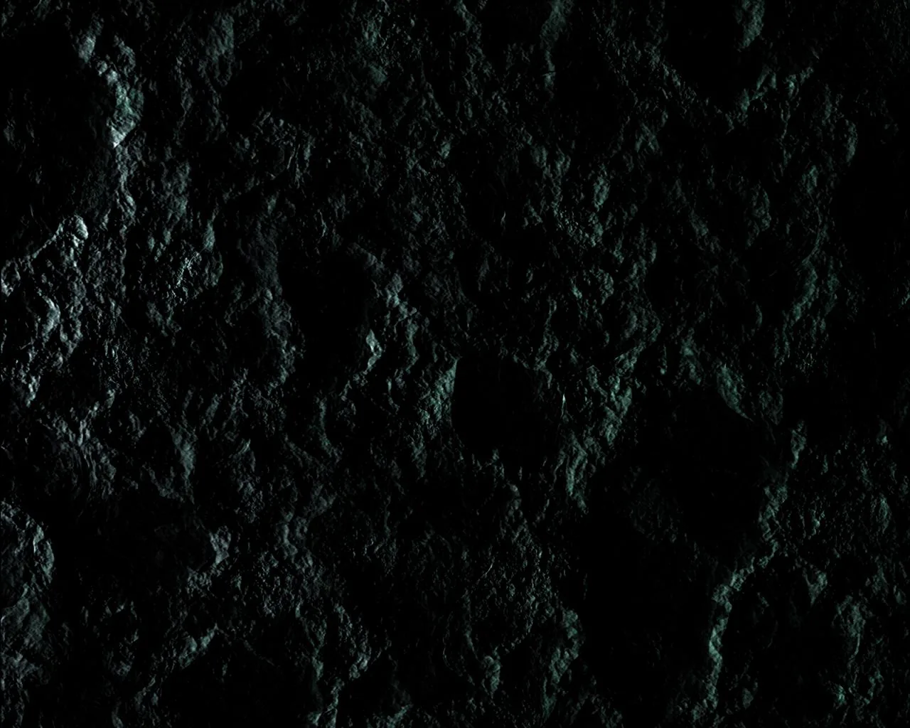 Craters pock a dark moon-like surface tinted faintly green, rim light from the upper left tracing every edge while the deepest shadow pools at bottom centre.