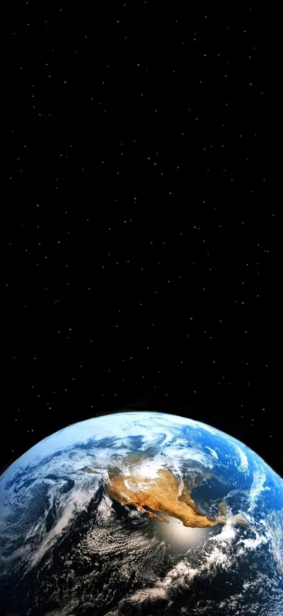 The planet sits low with a tan desert landmass catching the sun, the top two-thirds pure black star field so the clock and widgets stay readable.