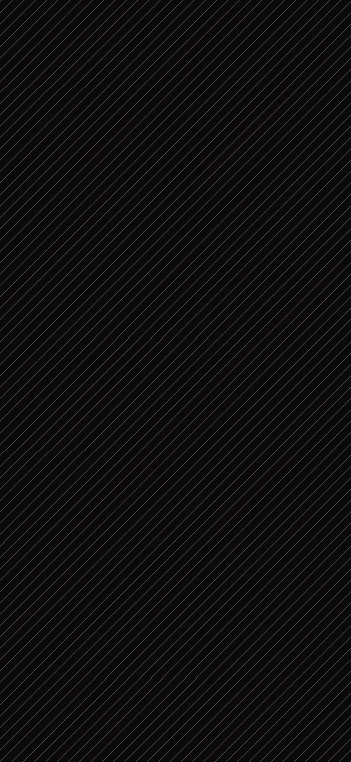 Ultra-fine diagonal ribbing runs corner to corner, so subtle it reads as plain darkness until the screen brightens, keeping every icon legible.