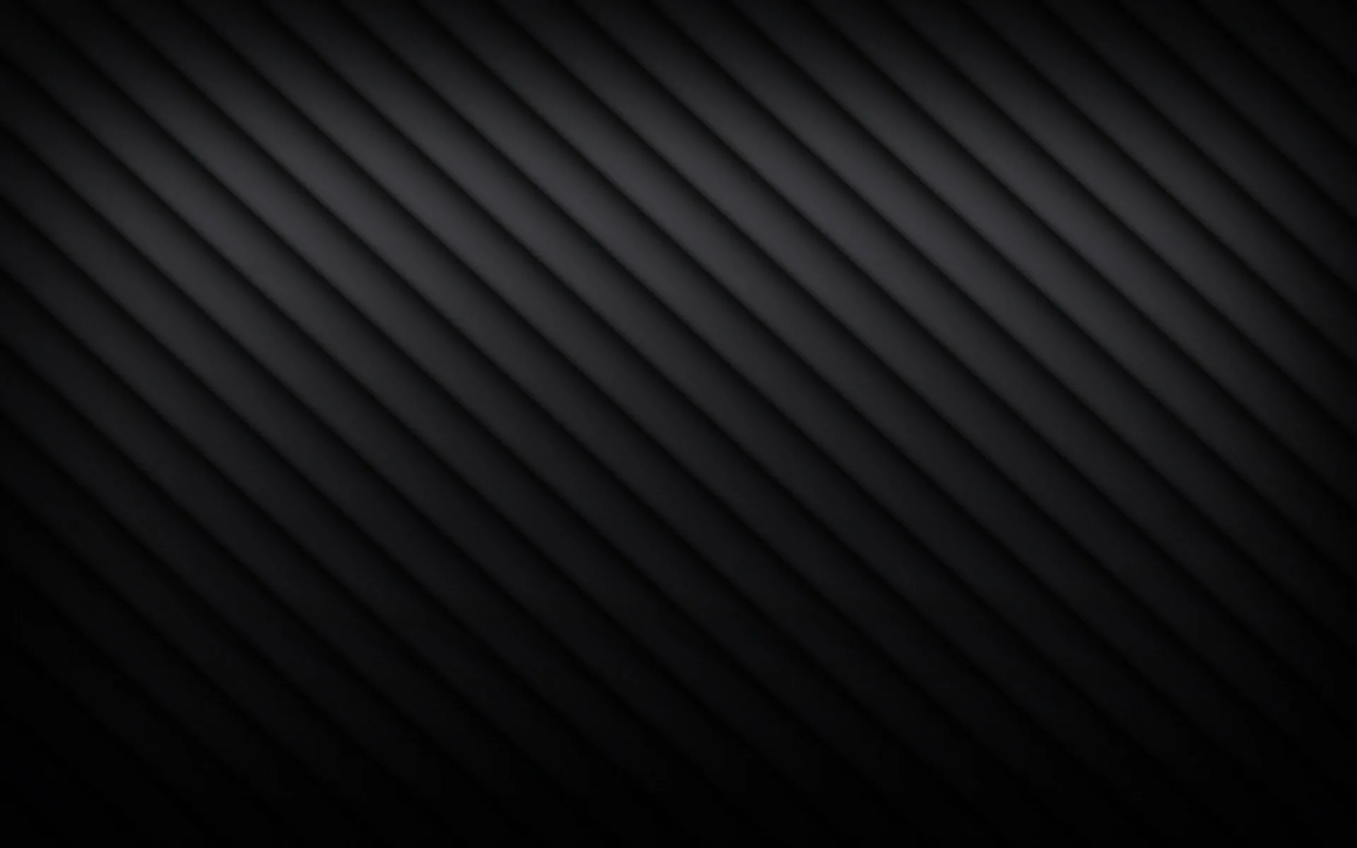 Soft diagonal bands run corner to corner in charcoal, brightest across the middle and sinking to true black at the edges.