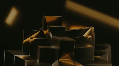 Folded angular blocks pile up across the lower half of the frame, warm gold spotlights raking in from the upper corners and leaving the sky above black.