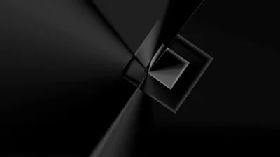 A single crease splits the frame into two black planes and a small raised square sits just right of centre, the only shape catching light.