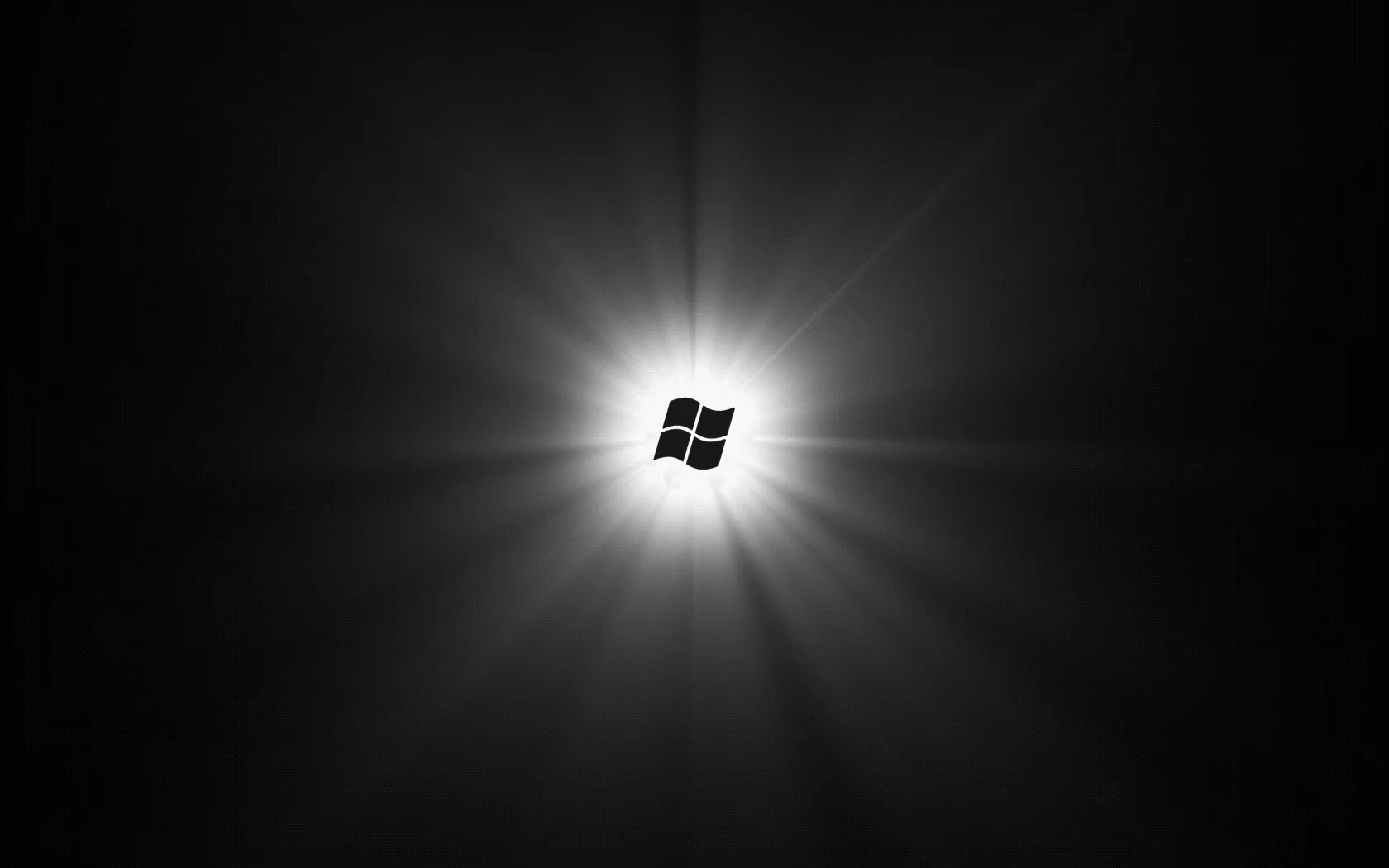 The window mark sits at the centre of a black field with sharp rays of white light radiating out from it.
