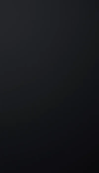 A flat charcoal field shading a shade lighter toward the top left, with nothing in the texture to compete with home screen icons.