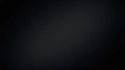 A blurred band of pale light runs corner to corner across a deep blue-black surface, the top-left and bottom-right dropping into full shadow.