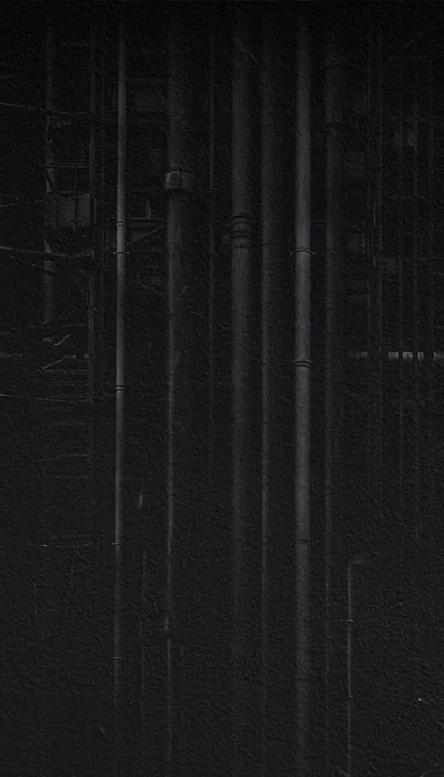 Thin pale streaks run top to bottom over a near-black surface, the lower third left almost entirely unbroken.