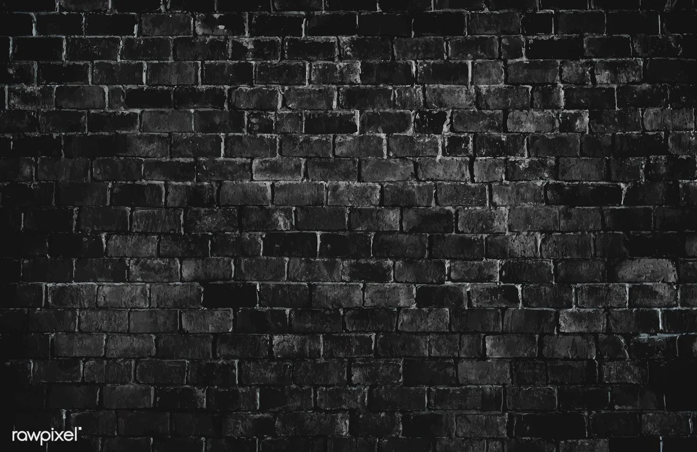 Rough painted brick in black and white, the mortar bright along the middle rows and the whole wall darkening steadily toward every edge.