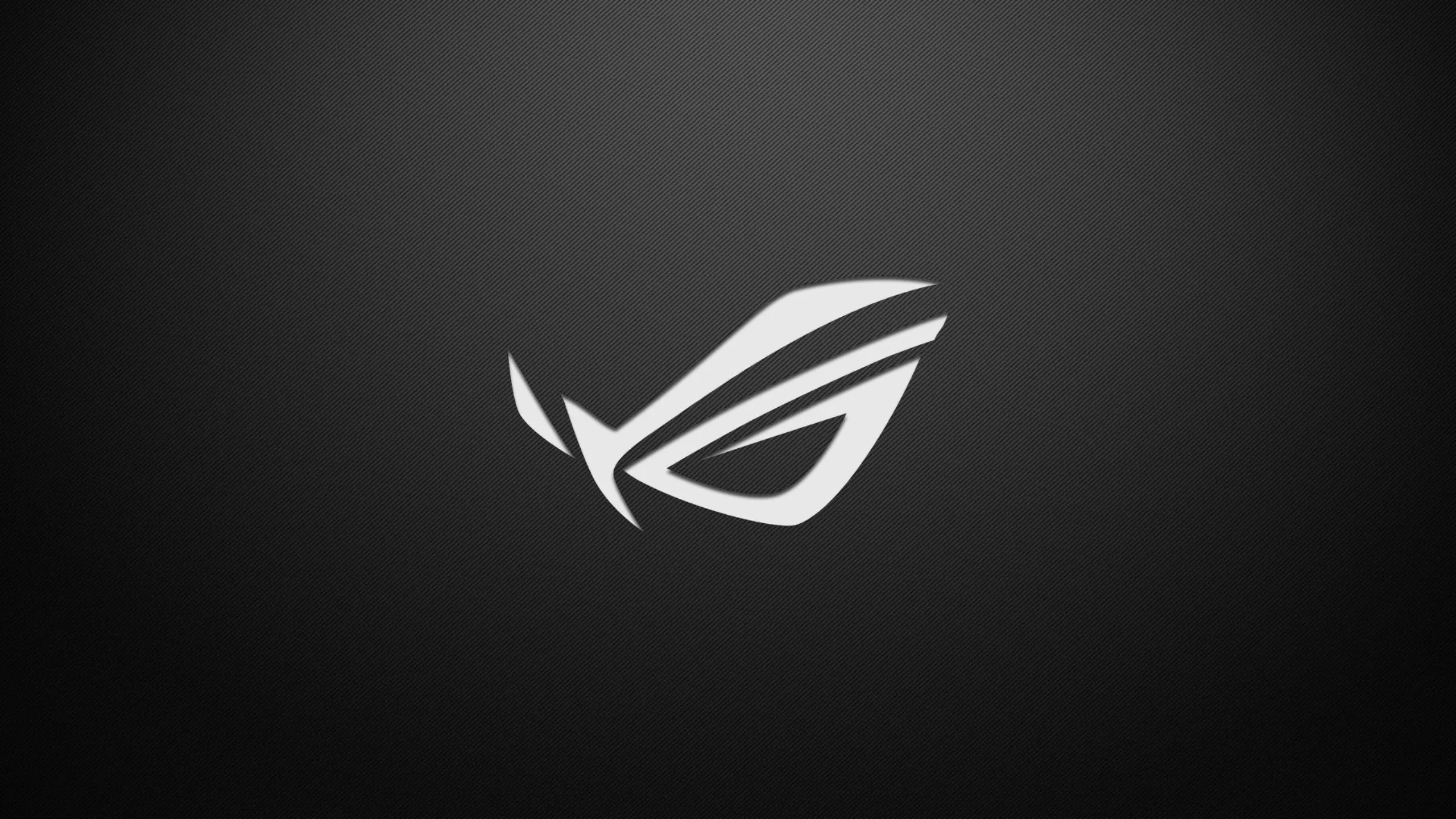 The ASUS ROG eye emblem in plain white, centred on a smooth charcoal gradient that brightens slightly toward the middle — a clean pick for gaming setups.