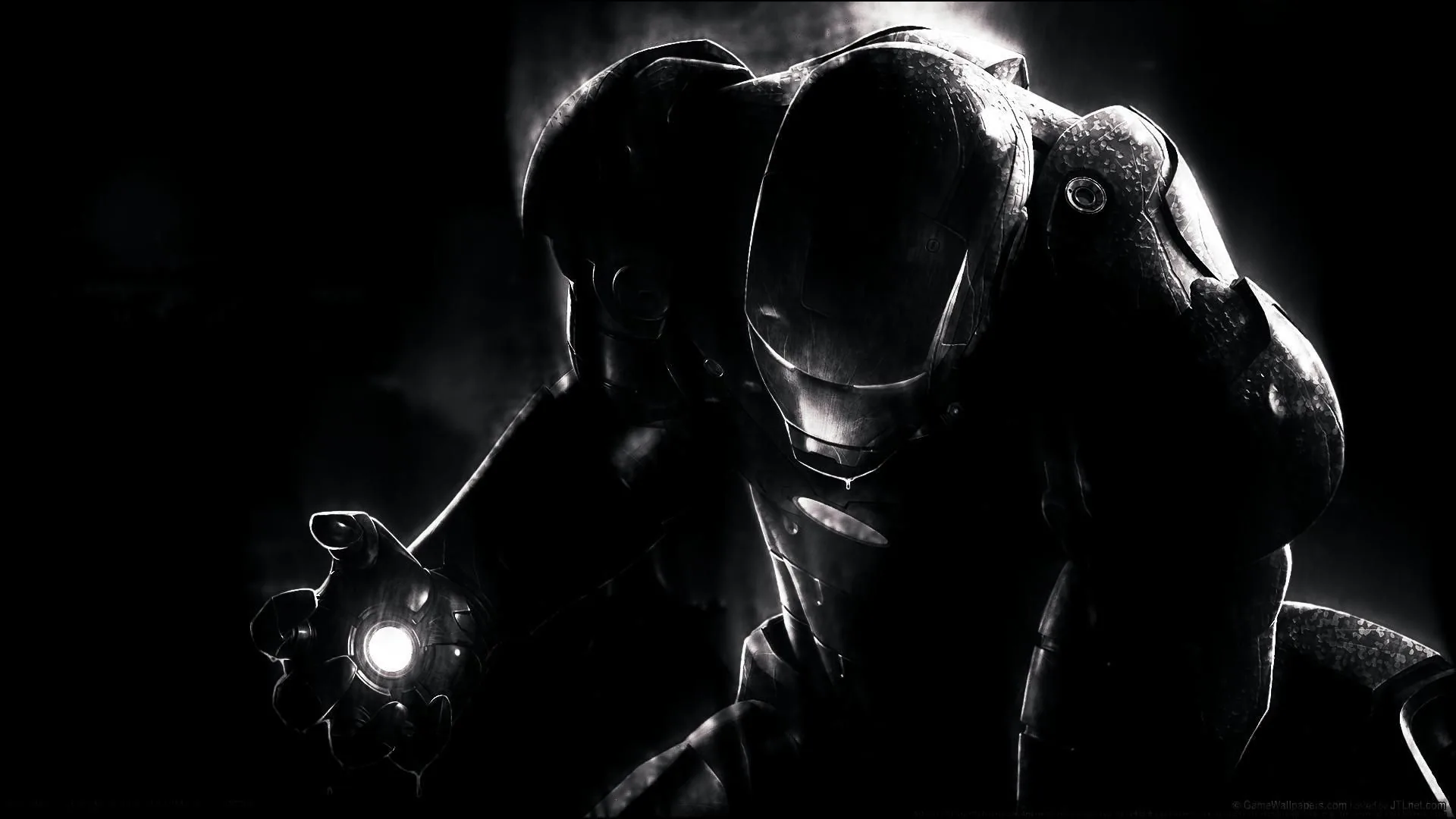 An armoured suit emerges from near-total darkness, the only light coming from the glowing repulsor in its raised hand.