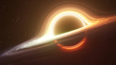 White hot light flares along the left of the disc while an orange glow ring wraps the sphere, the darkest area sitting in the lower right.