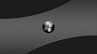 A polished Windows logo sits on a perforated metal panel, two dark curved bands sweeping behind it across the top and bottom.