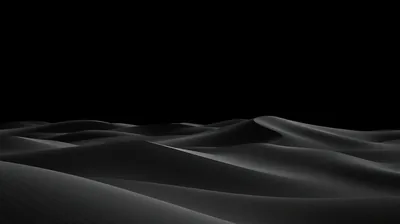 Low light rakes across a run of dunes, picking out each crest and leaving the sky above completely black.