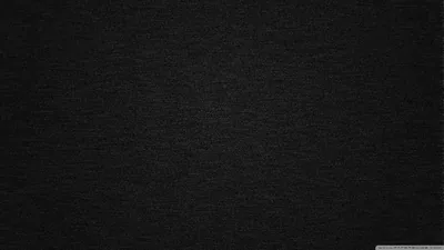 A tight linen-like weave runs edge to edge across the widescreen frame, lifting to soft grey through the upper middle before a vignette pulls the corners back to black.