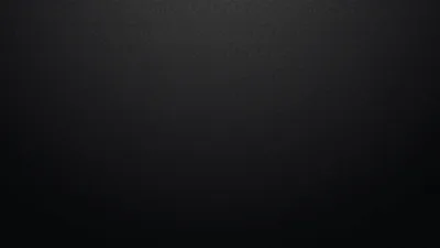 An even grey studio backdrop lifts a little toward the centre and falls away to near black at the top corners.