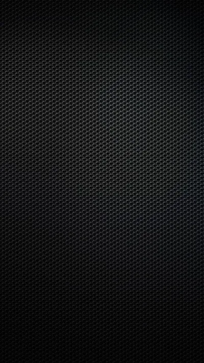 Tight rows of tiny holes cover the entire frame in matte black, a slow vignette darkening the four corners.