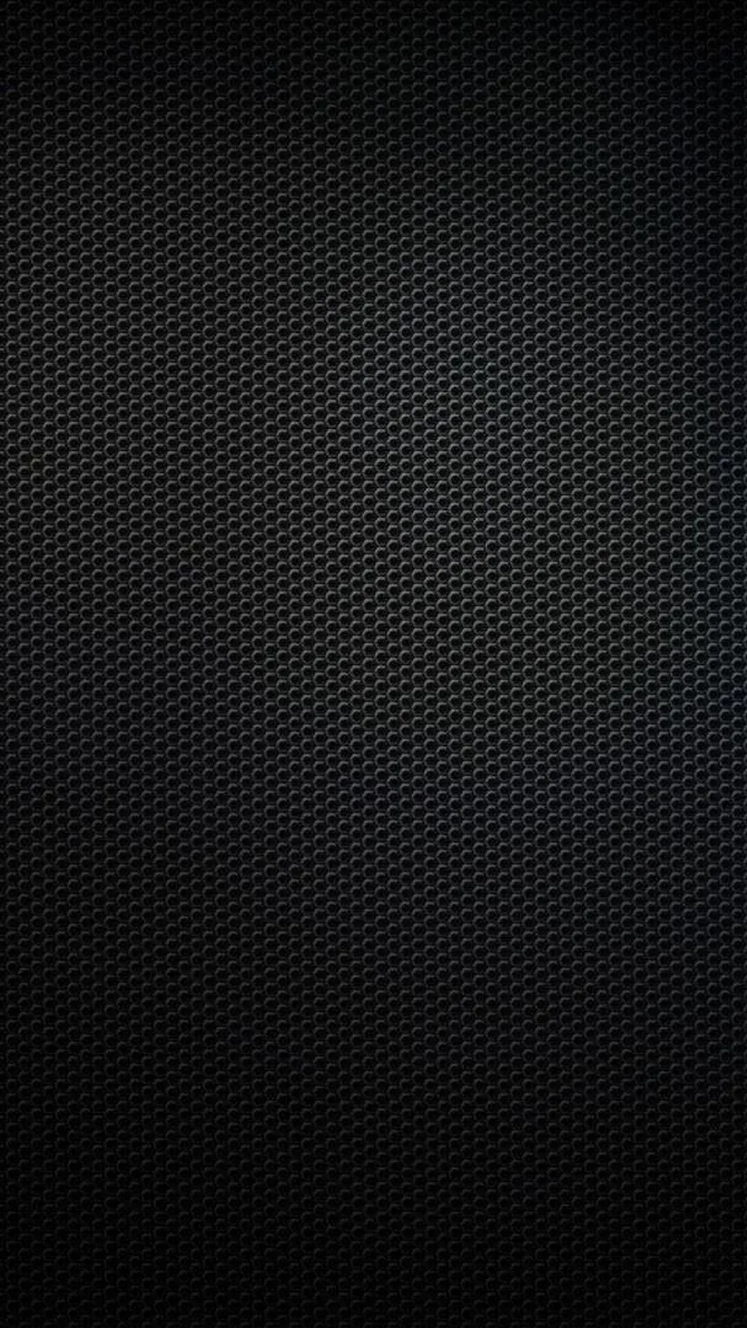 Tight rows of tiny holes cover the entire frame in matte black, a slow vignette darkening the four corners.
