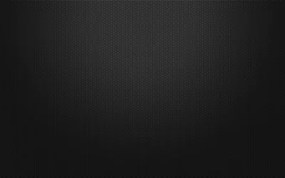 A fine woven mesh runs across dark grey, lit softly from the centre so the weave fades out before it reaches the corners.
