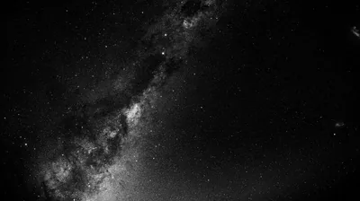 A black and white photograph of the galactic band running diagonally from the top toward the lower left, the right half only sparse pinpoint stars.