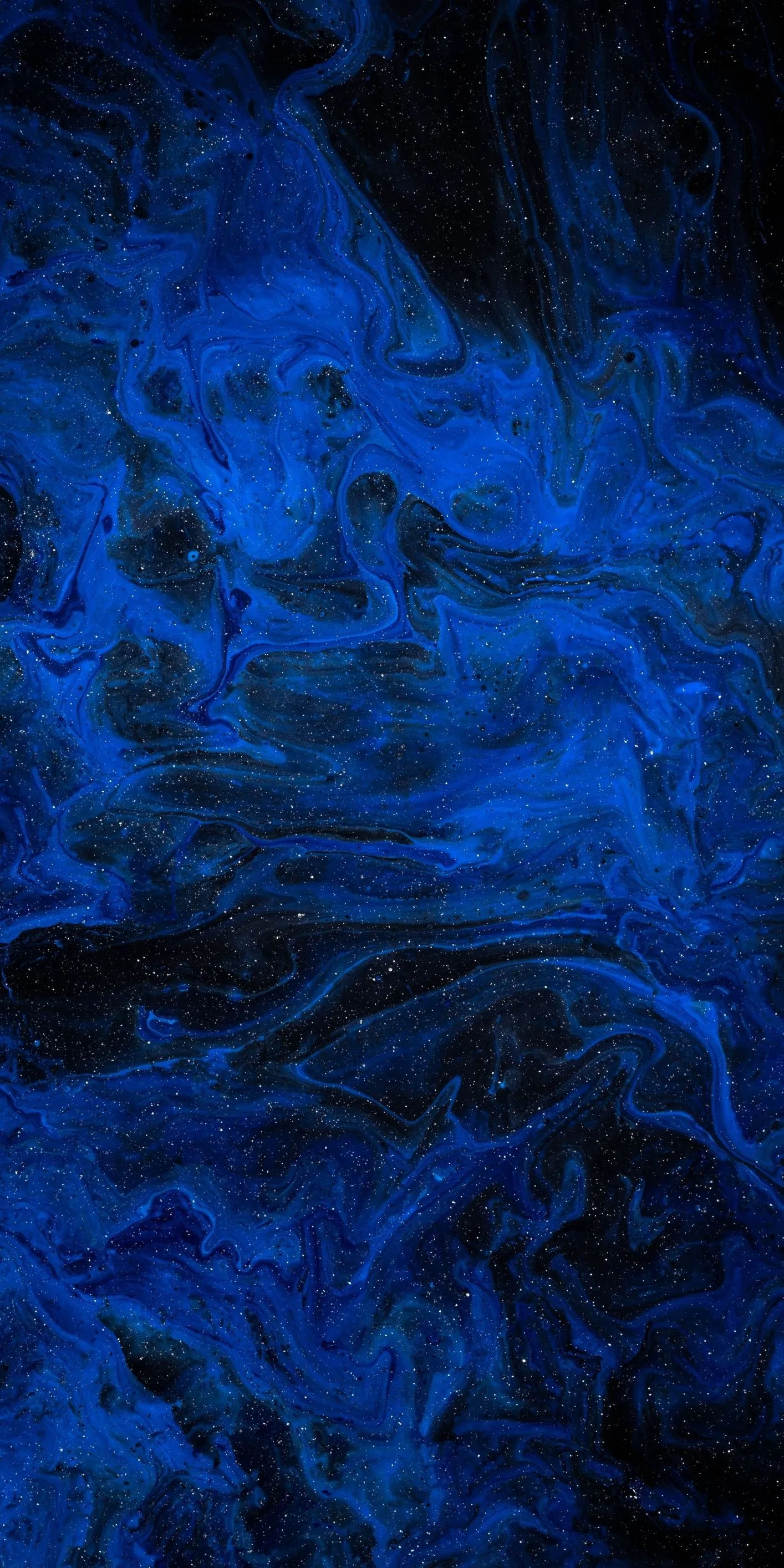 Navy and royal blue ink bloom through black in a tall marbled pattern, the paint splitting into fine threads near the bottom.