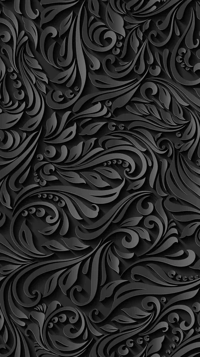 Thick carved scrollwork curls edge to edge in black relief, every ridge picked out by light coming from the upper left.