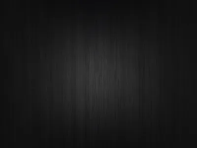 A soft light lands in the middle of a dark timber panel, the vertical grain running the full height of the frame.