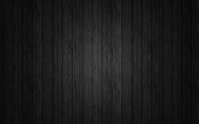 Vertical wooden boards run the full height, grain showing faintly in the lit middle band while the top and bottom drop into black.