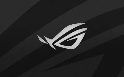 The ROG eye logo sits in white over sweeping charcoal brush strokes that run diagonally across a dark grey background.