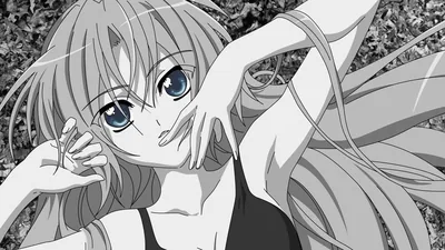 Everything is greyscale except two bright blue eyes as she lies back in tall grass, one arm stretched above her head.