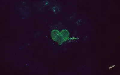 A heart of green nebula gas floats in a near-black starfield, faint teal clouds drifting across the upper corners.