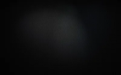 A honeycomb-textured sheet fills the frame, lit softly at the centre and dropping to black at every edge.