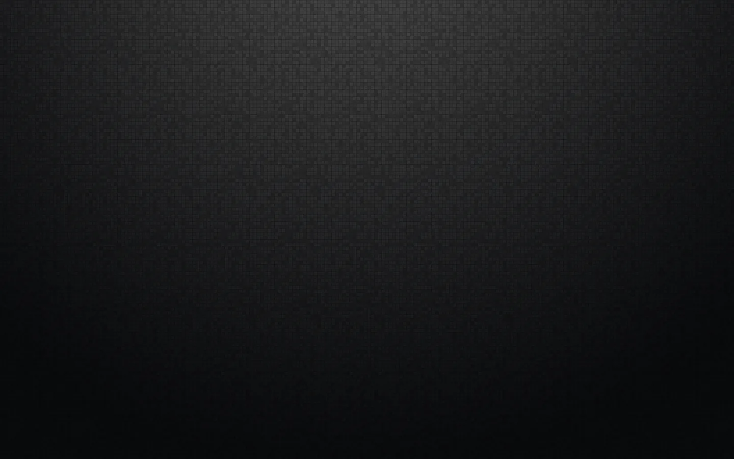 A finely grained dark surface lit from above so the top third lifts to grey, the bottom corners falling into black.
