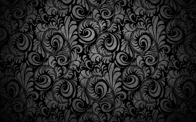 Curling acanthus leaves and floral scrolls repeat across the frame in grey on black, brighter through the middle band and darker at the edges.