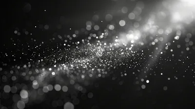 A diagonal drift of out-of-focus white specks crosses the frame, the bokeh loosest in the lower left and tightest near the centre.