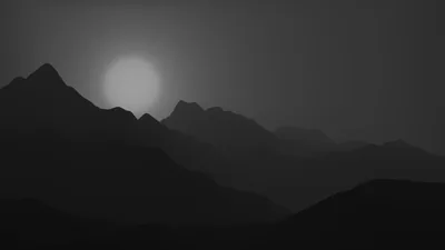 Layered ridges fade back into haze under a soft grey sun, each range a shade paler than the one standing in front of it.