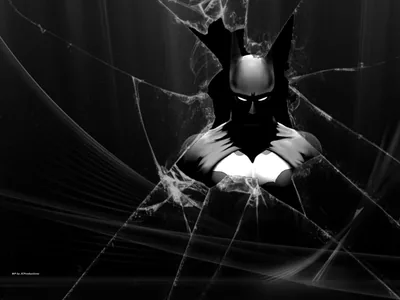The cowled figure looms through a pane broken from the centre, white eyes and chest catching the light while cracks web out to the edges.