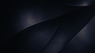 Ribbed folds of dark navy material curve through the frame, the ridges catching just enough light to separate.