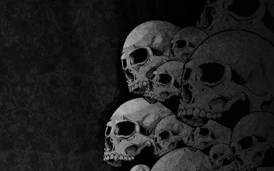 Human skulls piled shoulder-high on the right side, a faded damask pattern just visible on the dark wall behind them.